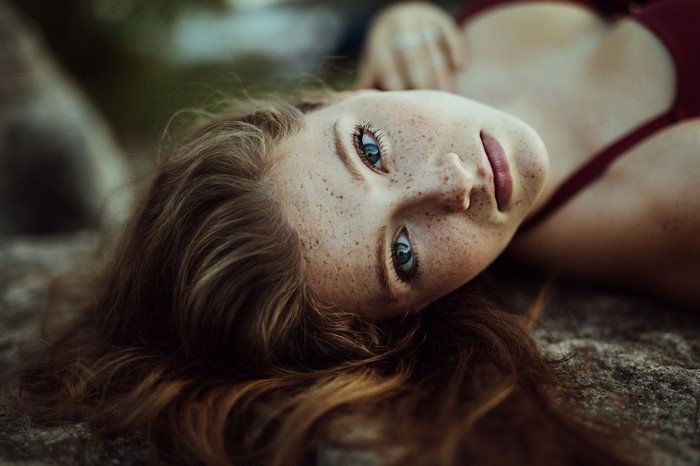 Woman with freckles lying down