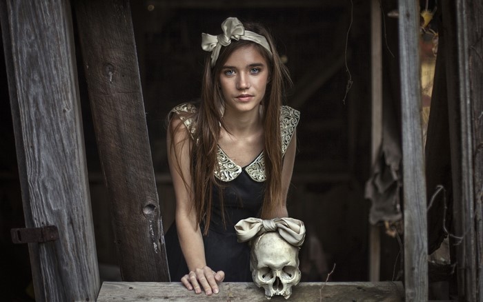 Woman in dress with skull and bow