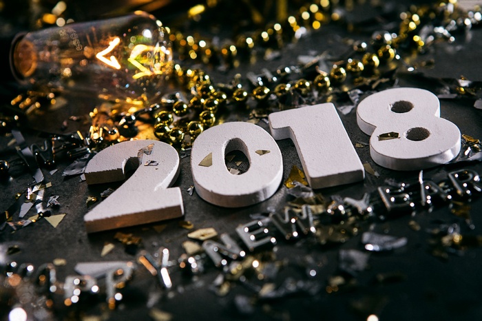 2018 New Year celebration with light bulb and confetti