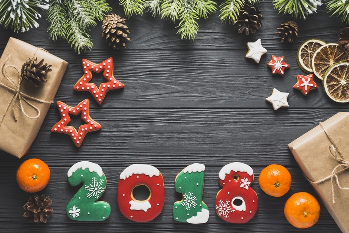 Christmas cookies in the shape of 2018, tangerines, and pine cones