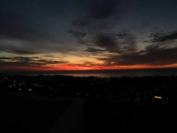 City skyline at sunset over the ocean