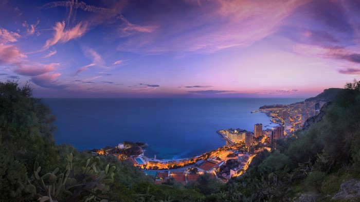 Monaco cityscape at dusk with ocean and sky