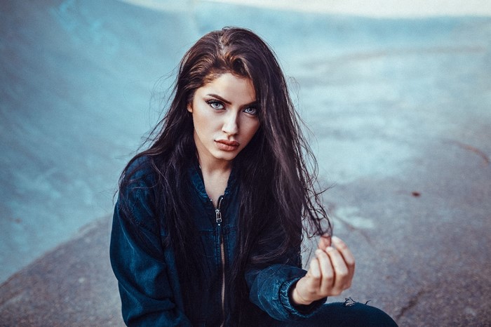 Woman with long dark hair and blue eyes
