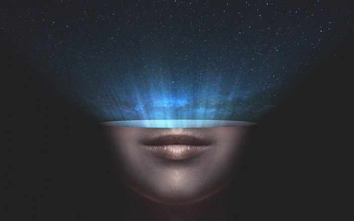 Woman's face with galaxy in place of eyes