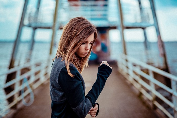 Woman on a pier looking down