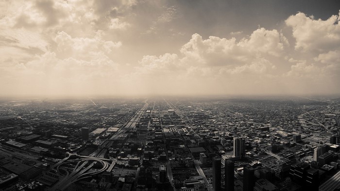 Aerial view of a sprawling cityscape under a cloudy sky