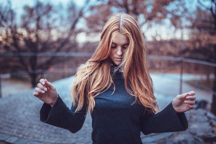Woman with long red hair outdoors