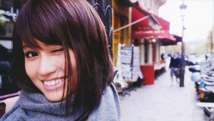 Atsuko Maeda winks and smiles on a Parisian street