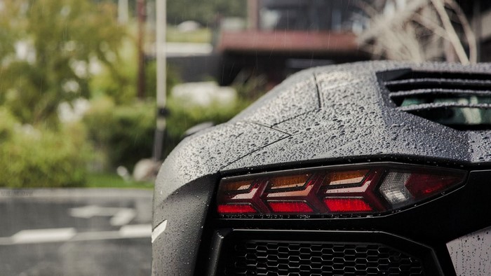 Black Lamborghini Aventador in the rain