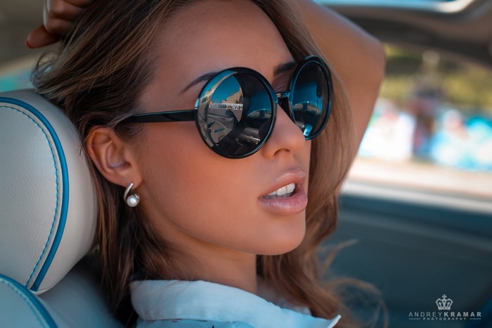 Woman wearing sunglasses in a car