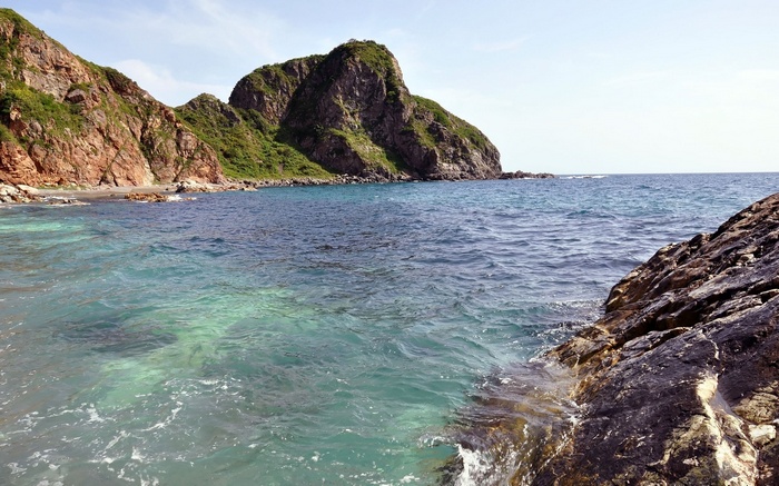 Rocky coastline with clear blue ocean water