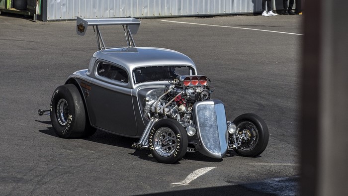 Silver and grey hot rod drag car with large rear wheels
