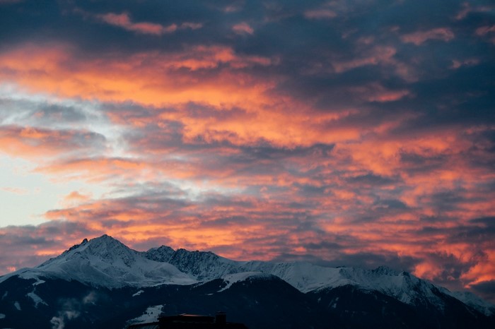 Snowy mountains under a colorful sunset sky