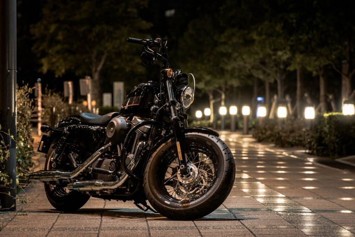 Black Harley Davidson motorcycle parked at night
