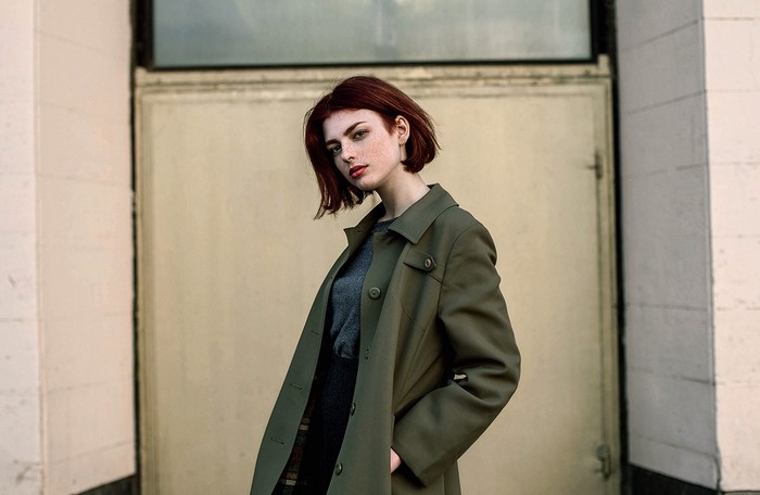 Woman with red hair and freckles wearing a coat