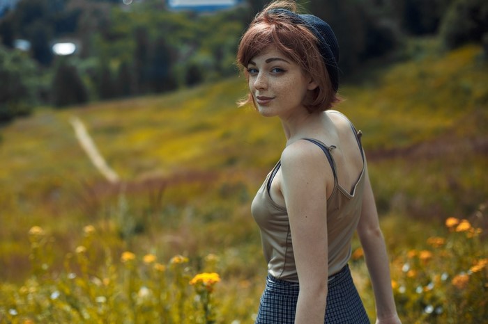 Redhead Woman in Field Looking Over Shoulder