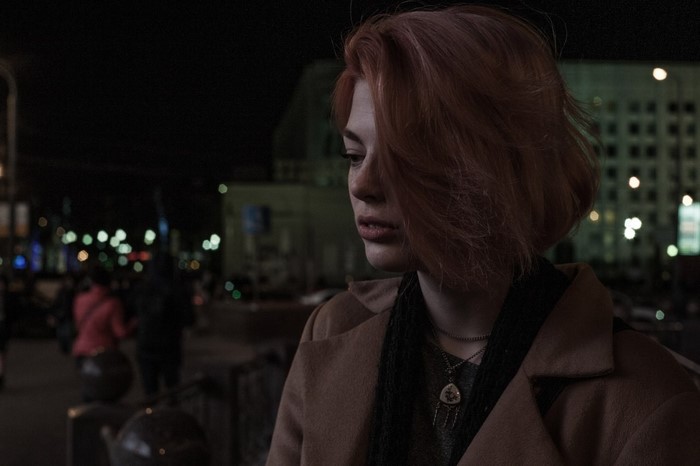 Redhead woman looking away at night