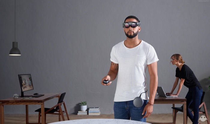 Man wearing Magic Leap headset with controller