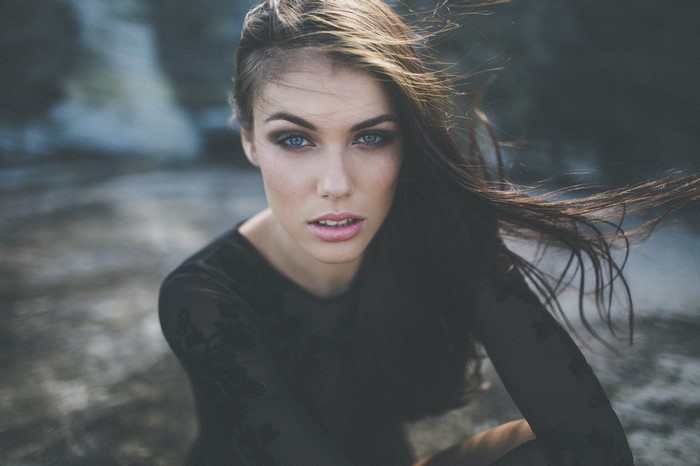 Woman with blue eyes and brown hair in the wind