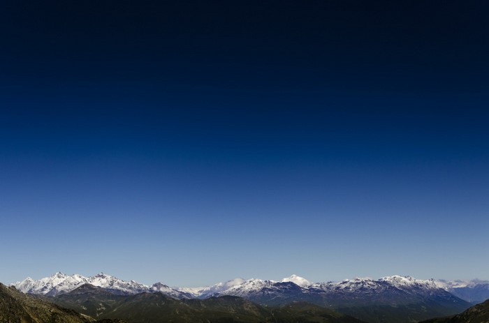 Snow-capped mountains under a clear blue sky