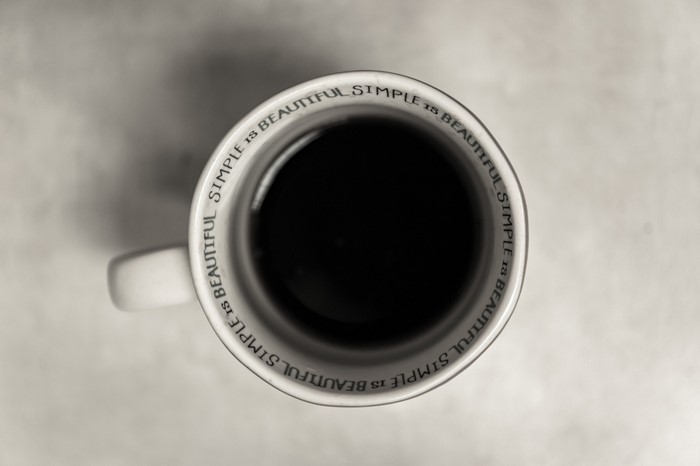 Overhead view of a coffee cup with text