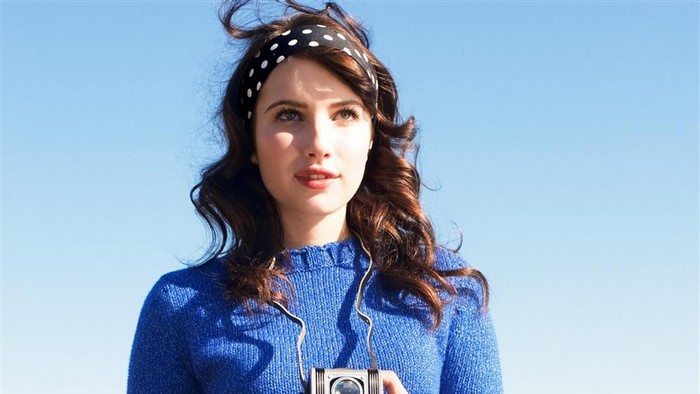 Emma Roberts with a camera and polka dot headband