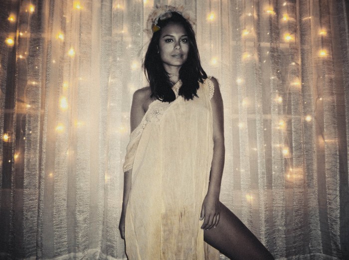Nathalie Kelley in a flowing dress with fairy lights