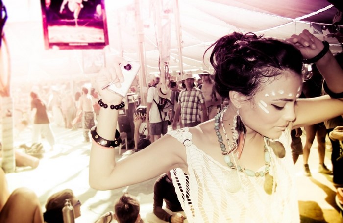 Woman with face paint dancing at an outdoor event