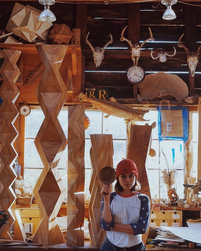 Nathalie Kelley in a wood carving studio