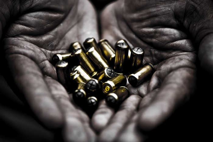Hands holding bullets
