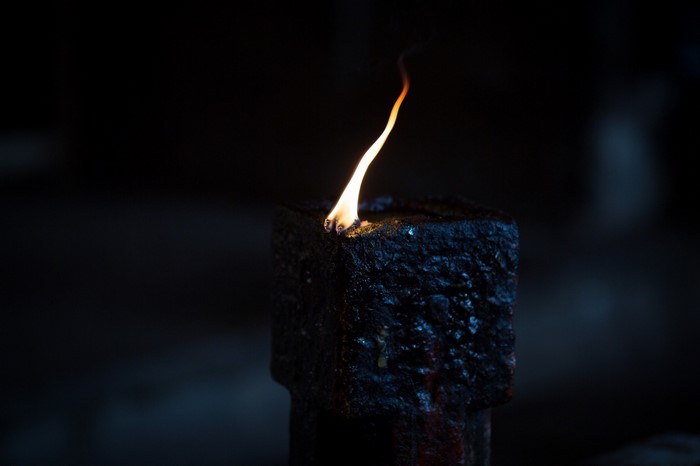 Close-up of a burning oil lamp in the dark
