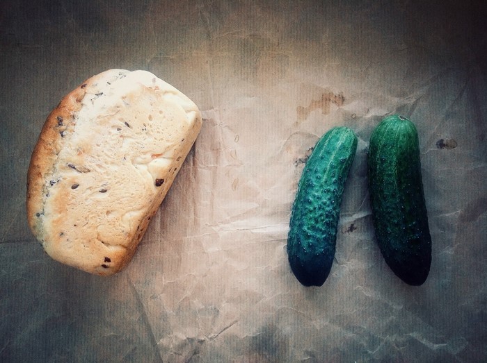 Bread and cucumbers on paper