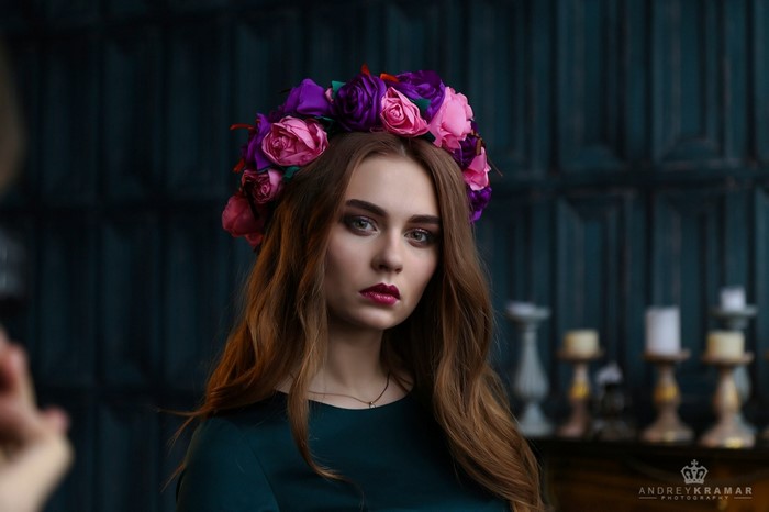 Woman with flower crown in dark green dress