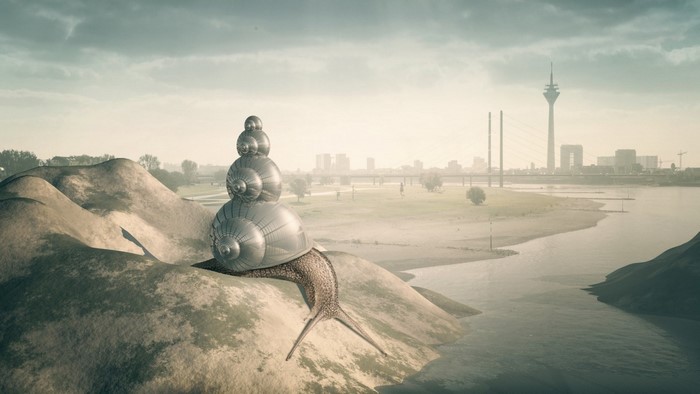 Giant snail sculpture on hills overlooking a city and river