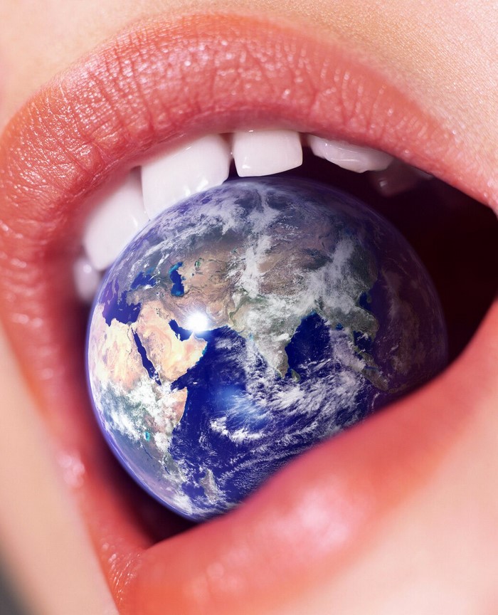 Woman's mouth with Earth in it