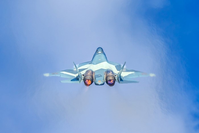 Sukhoi Su-57 fighter jet in flight with afterburners