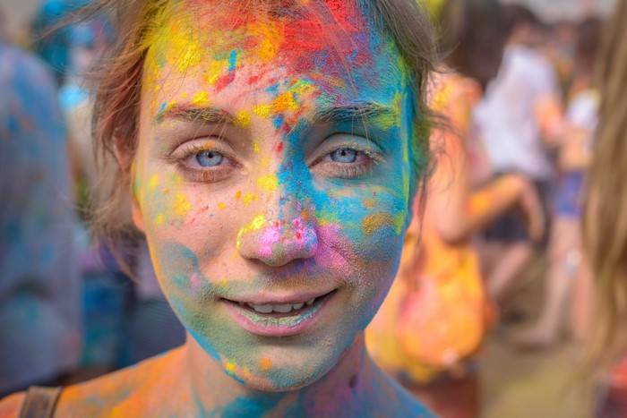 Woman covered in colorful powder at Holi festival