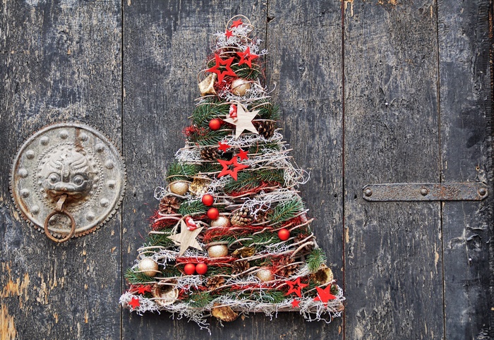 Christmas tree decoration with ornaments on a wooden door