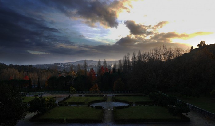 Garden with trees and mountains at sunset
