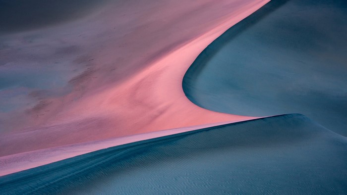 Pink and blue sand dunes at sunset