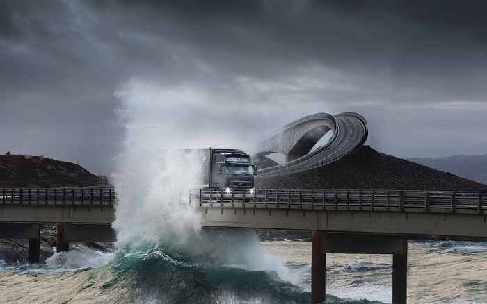 Volvo truck on Storseisundet Bridge in Norway during a storm