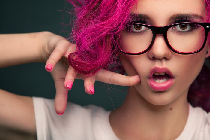 Woman with pink dyed hair and glasses