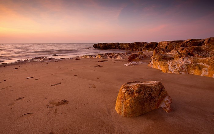 Beach with rocks at sunset