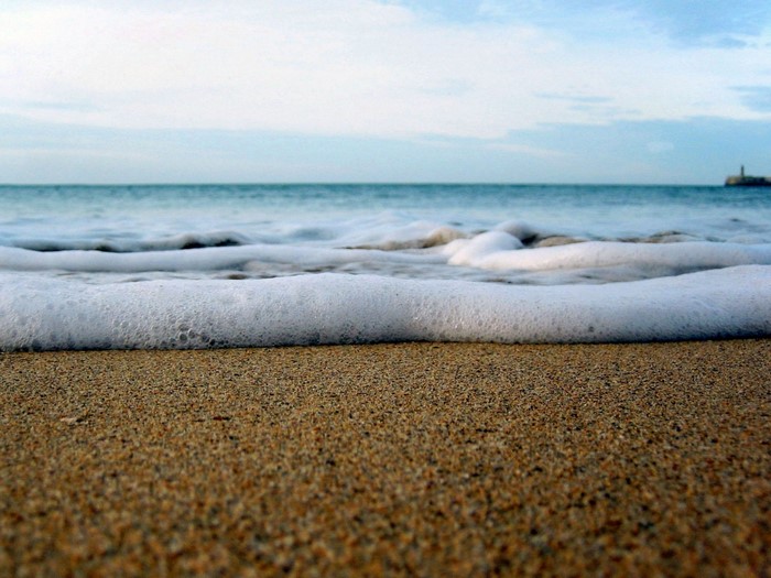 Ocean waves washing onto a sandy beach