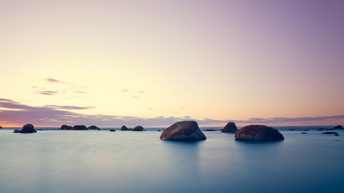 Ocean sunset with rocks and clouds
