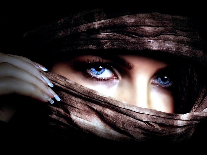 Close up portrait of a woman with blue eyes and brown headscarf