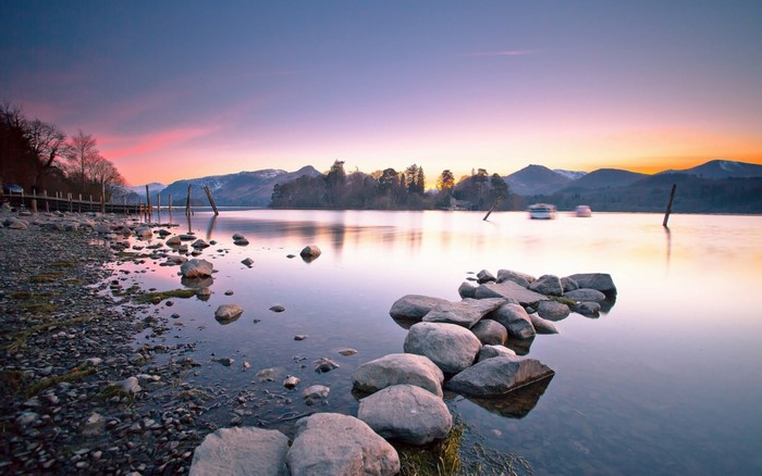 Lake at sunset with island and mountains