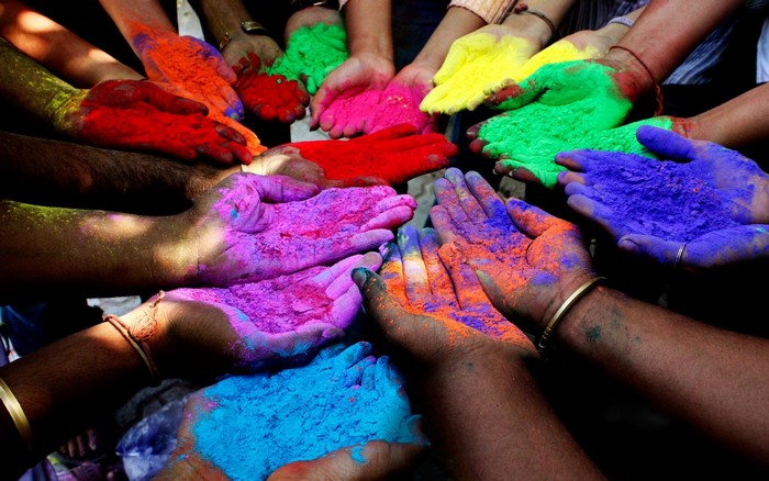 Hands holding colorful powders during Holi festival