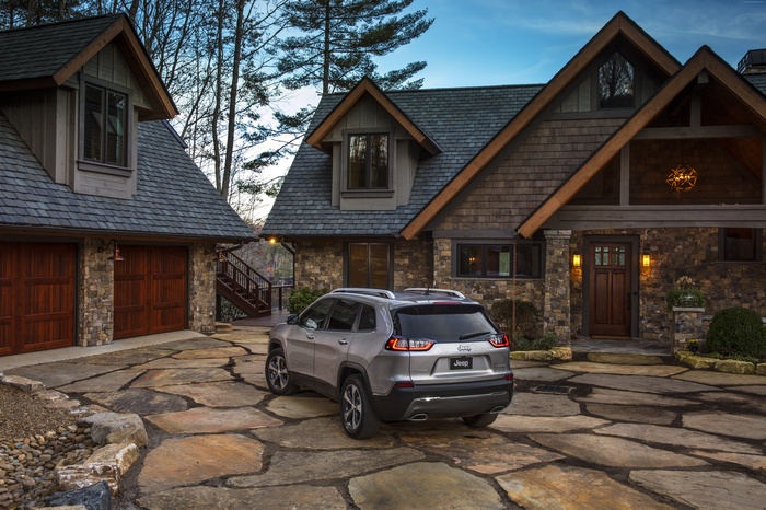 2018 Jeep Cherokee parked in front of a stone house