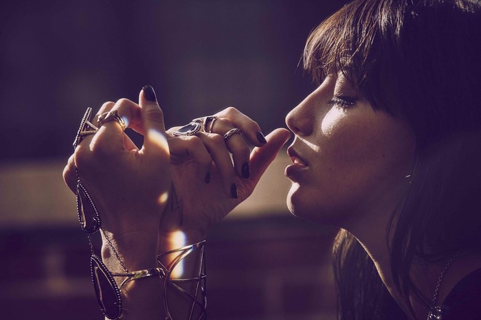 Woman with rings and bracelets touching her face
